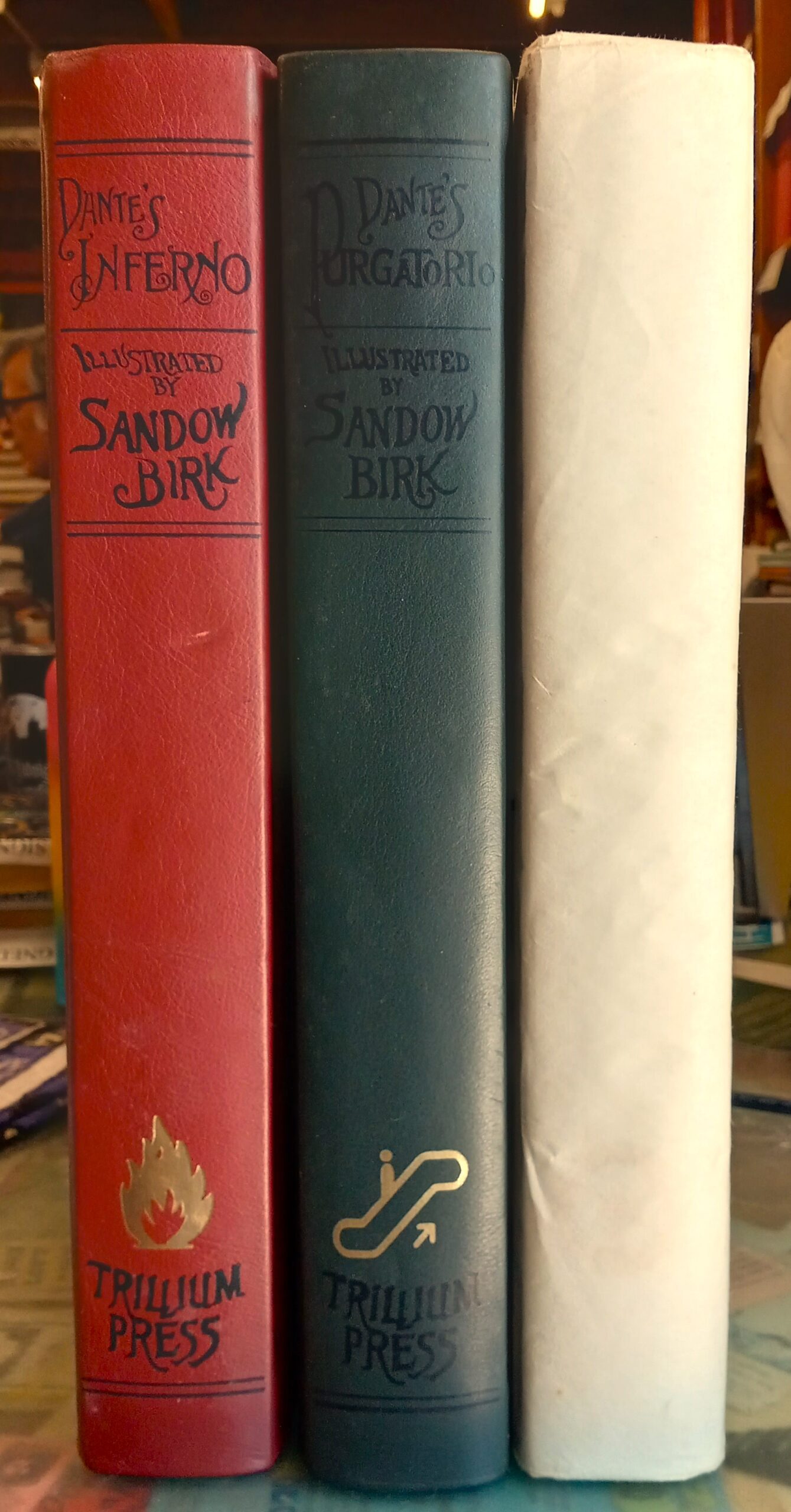 Spines of all three volumes of The Divine Comedy illustrated by Sandow Birk