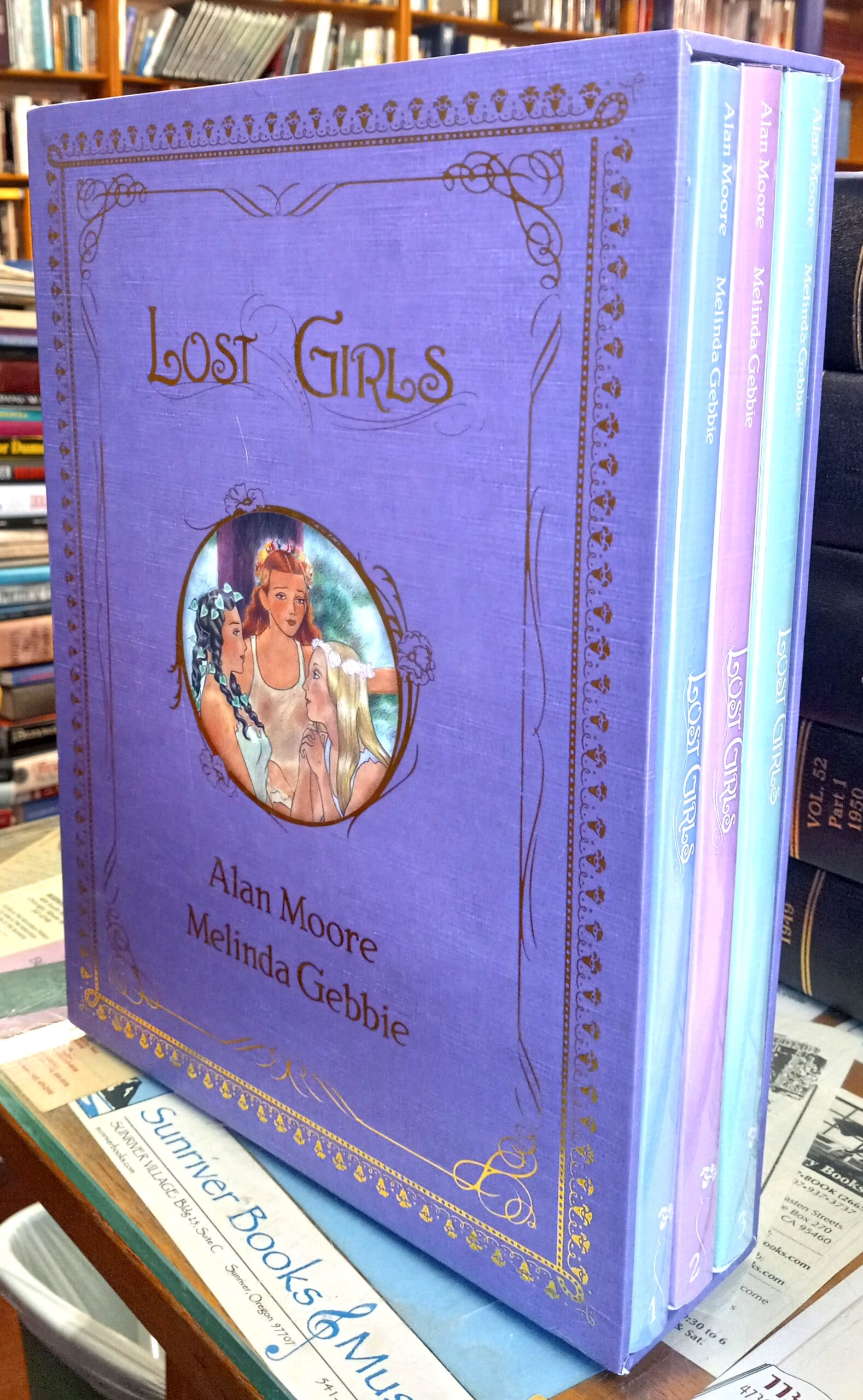Lost Girls jacketed spines of all three volumes inside slipcase
