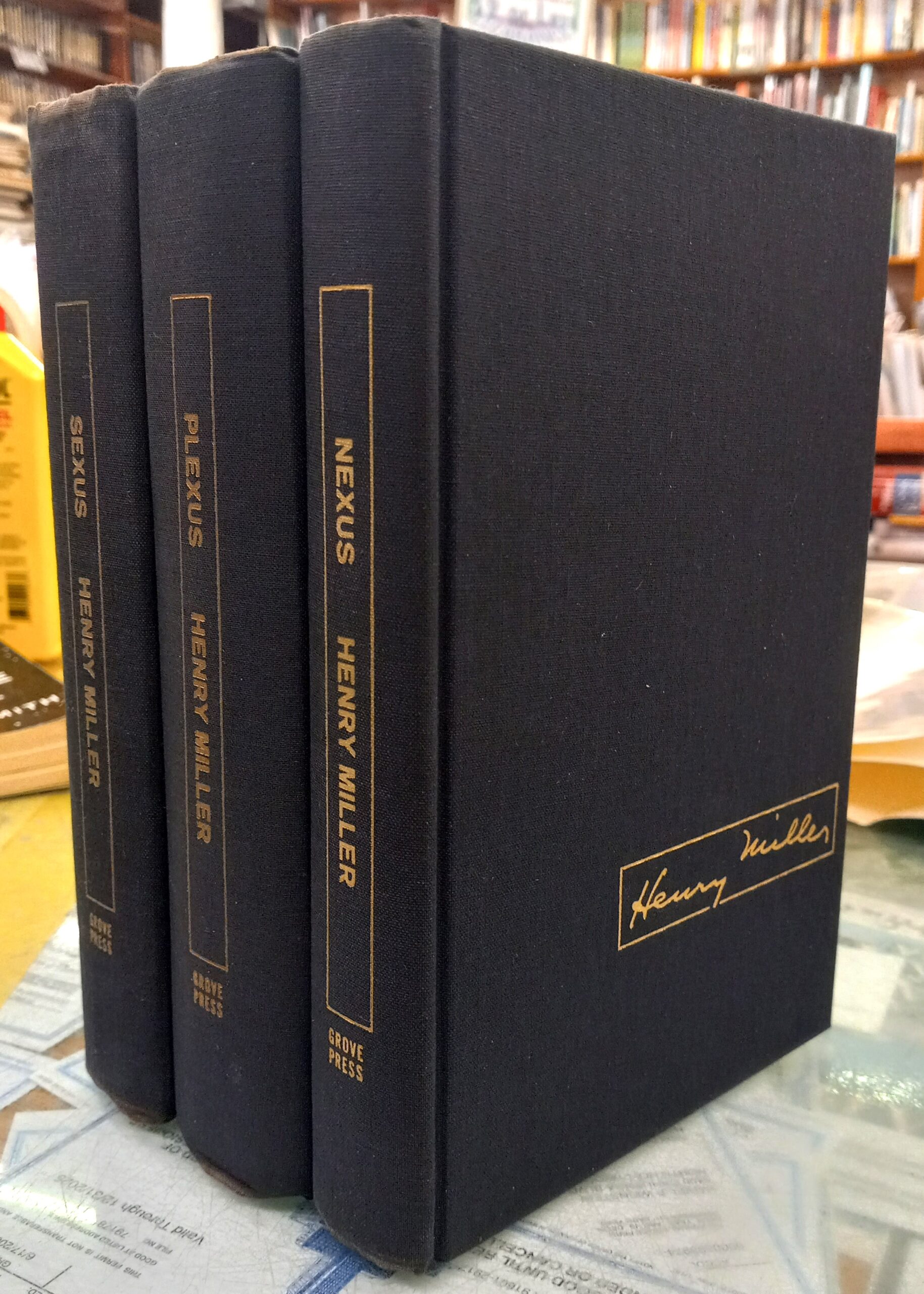 The Rosy Crucifixion binding spines of all 3 volumes and front board of one