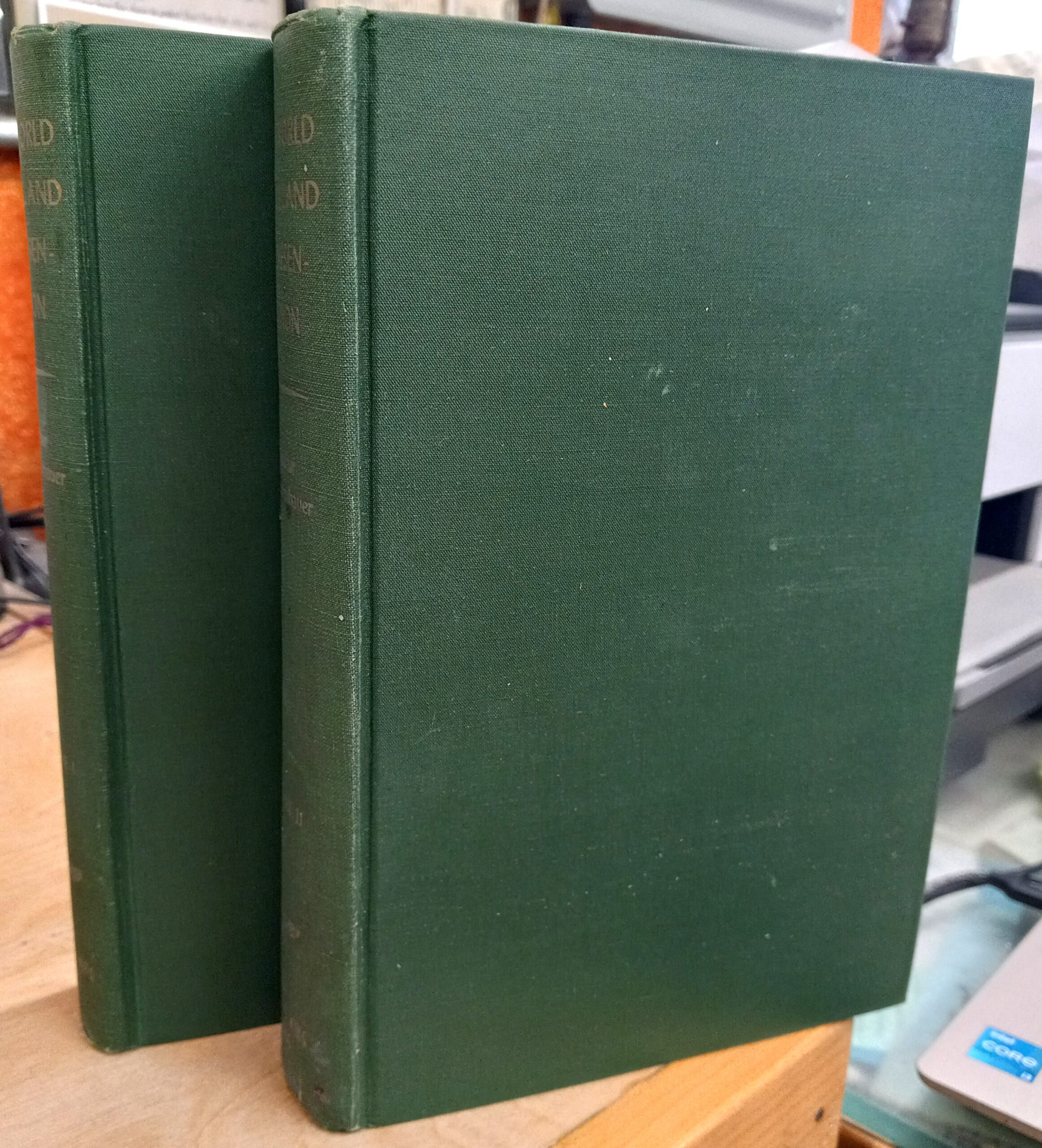Spines of both volumes and front board of one volume