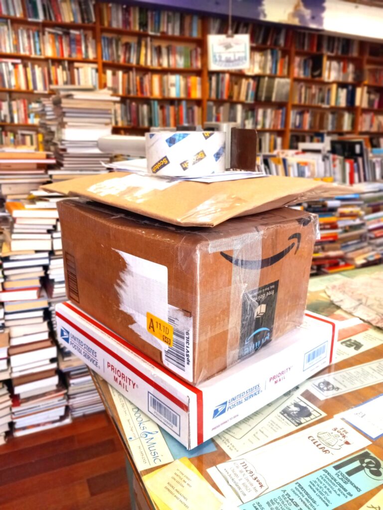 Boxes atop a counter with books in the background