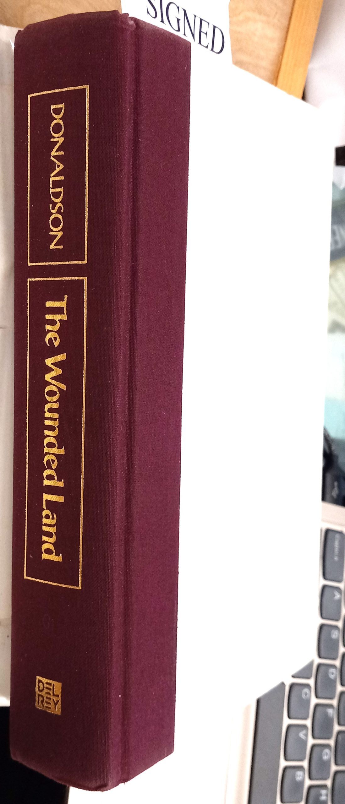 The Wounded Land binding spine and front board